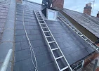 Slate roof with roofing ladder and chimney